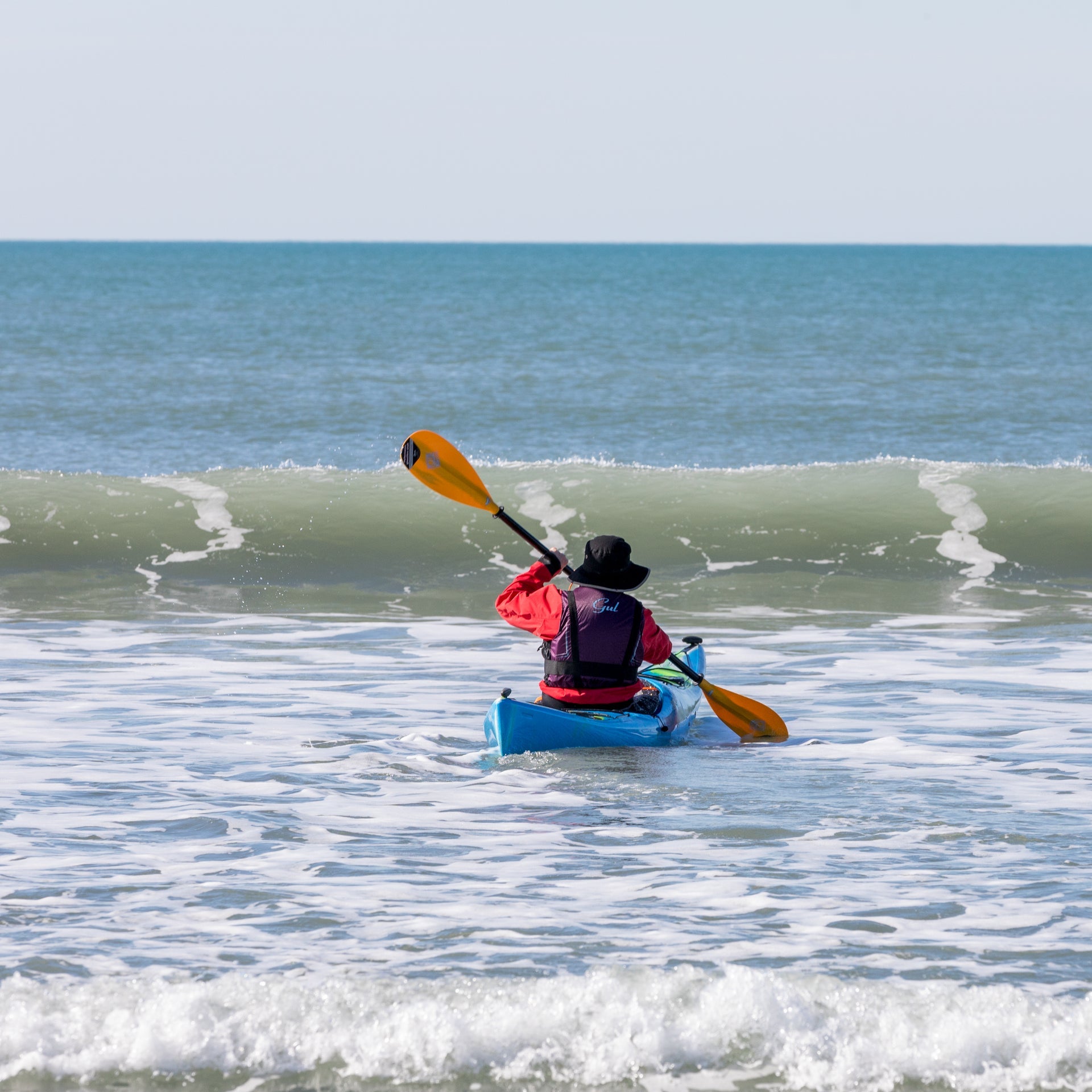 A man kayaking at Garrylucas White Strand beach