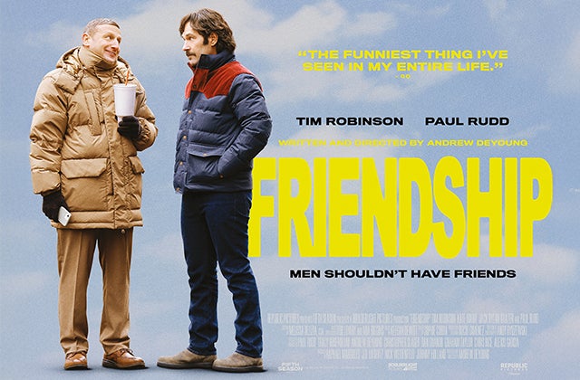 2 men in thick winter jackets talking to each other