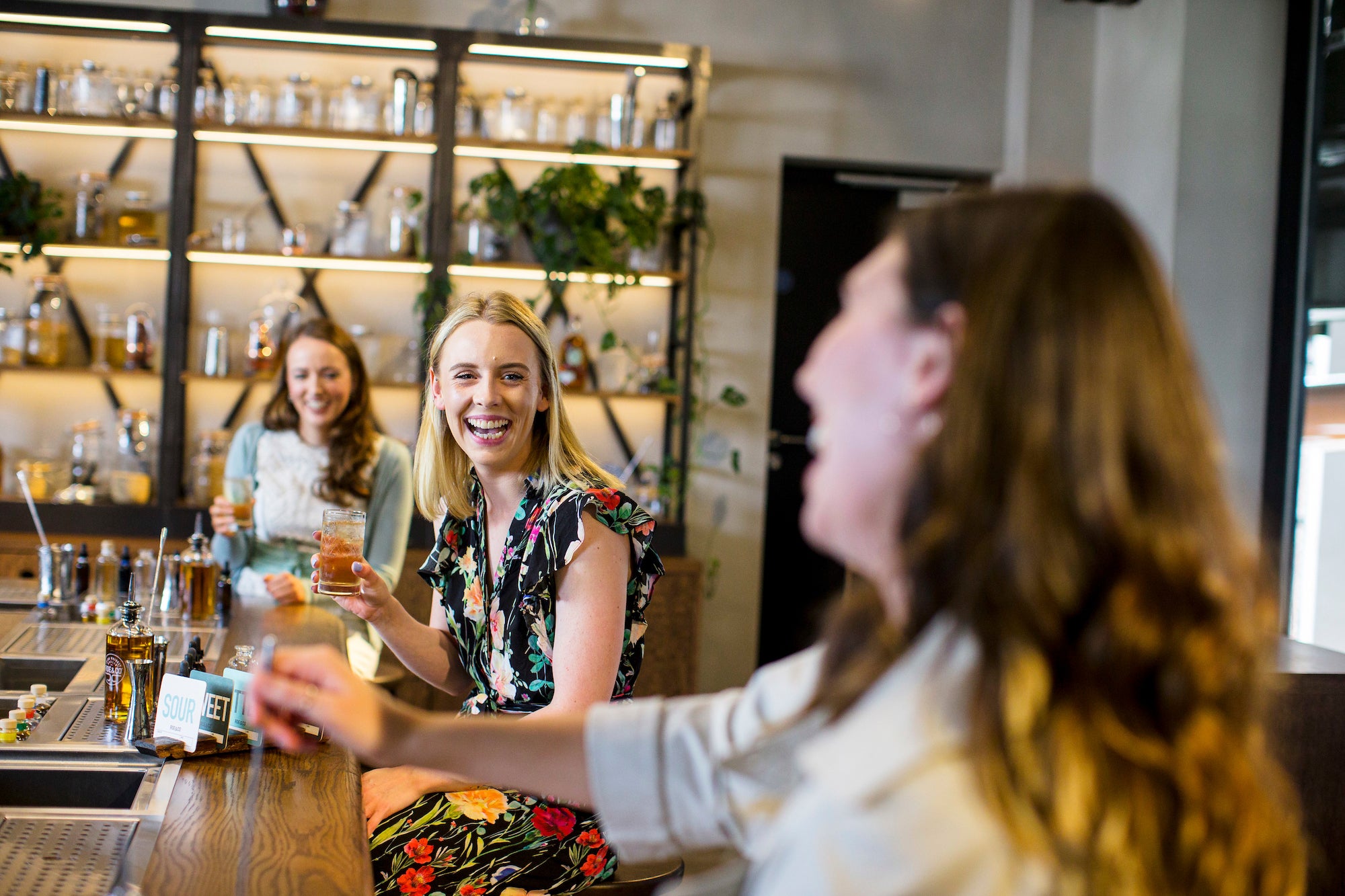 Three women enjoying a tour of Roe & Co Distillery in Dublin City.
