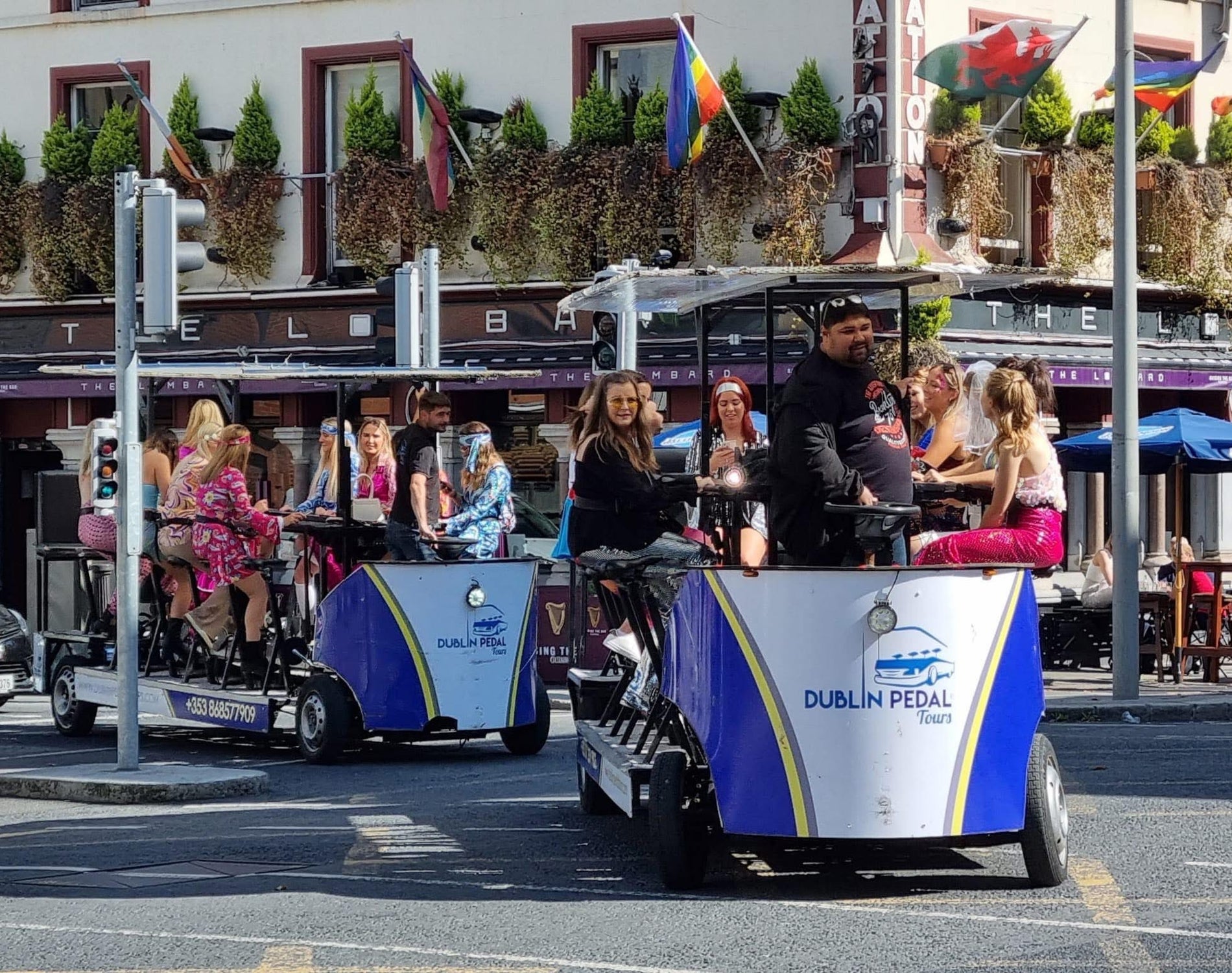 A group riding two Dublin Pedal Tours bikes through a busy city street