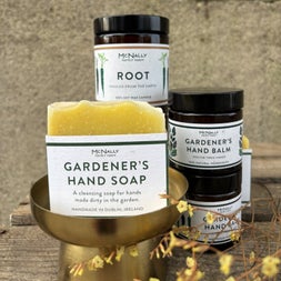 Yellow bar of McNallys soap and jars of cosmetics