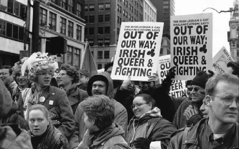 Black and white photo of people in a demonstration holding up signs
