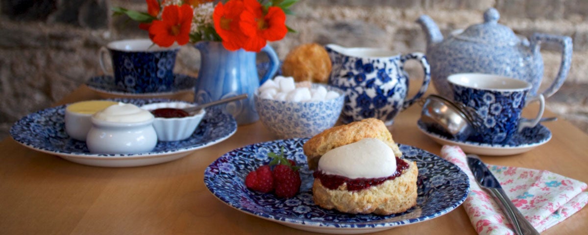 Freshly baked scones served with cream jam and tea in The Ballymaloe Shop and Café