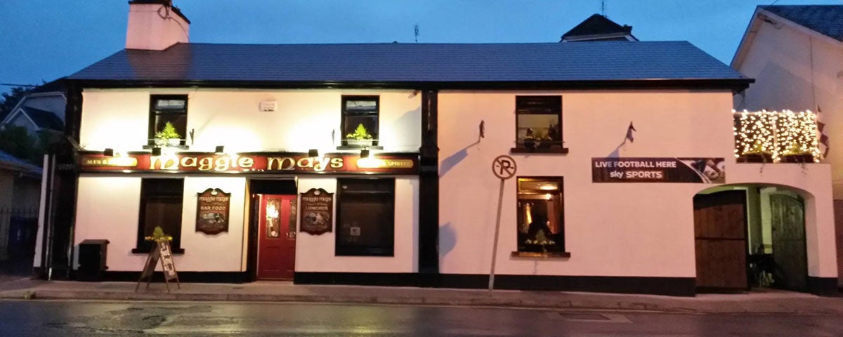 The exterior of Maggie Mays Restaurant in Loughrea on a darkening evening with the exterior lighting on