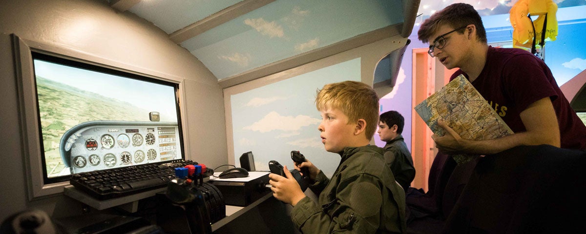 A boy taking a simulated flying lesson in the Shannon Aviation Museum