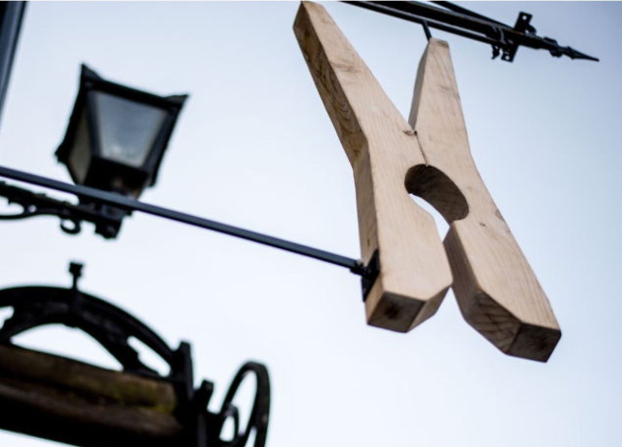A large clothes peg sign outside The Washerwoman restaurant