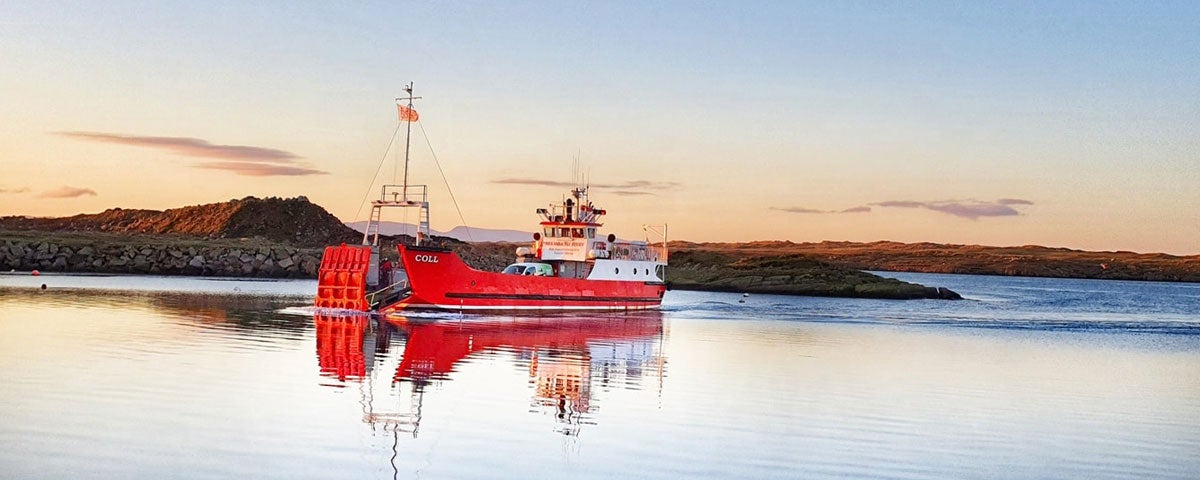 The Arranmore Car Ferry on its way to Arranmore Island with some hills in the background