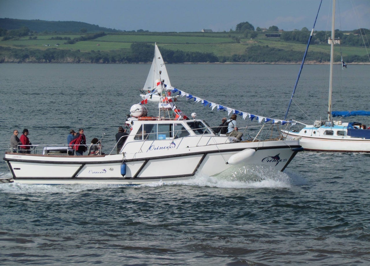 A boat at sea with some passengers onboard