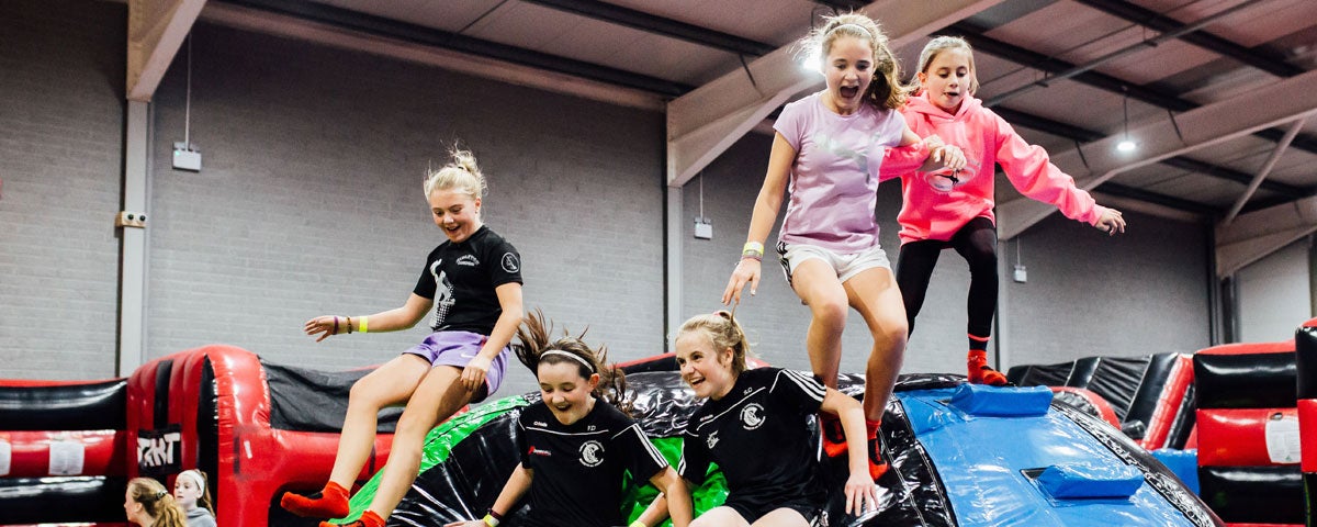 A group of children enjoying the Inflata drop slides