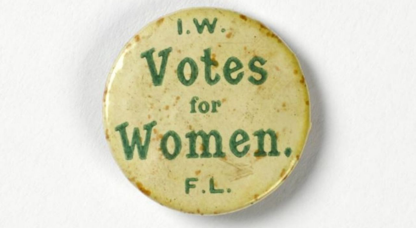 Badge worn by Francis Sheehy Skeffington and taken from his coat after his death in 1916. Metal, covered celluloid white, with "Votes for Women I.W.F.L." in green. Retailer's tag of Peter Callaghan, 8