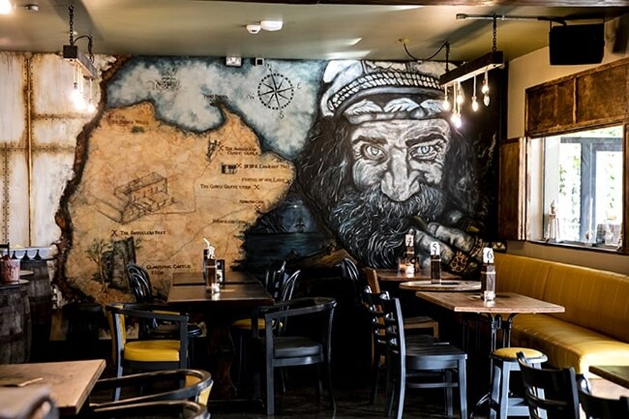 A wall decorated with a mural in Smuggler's Rest