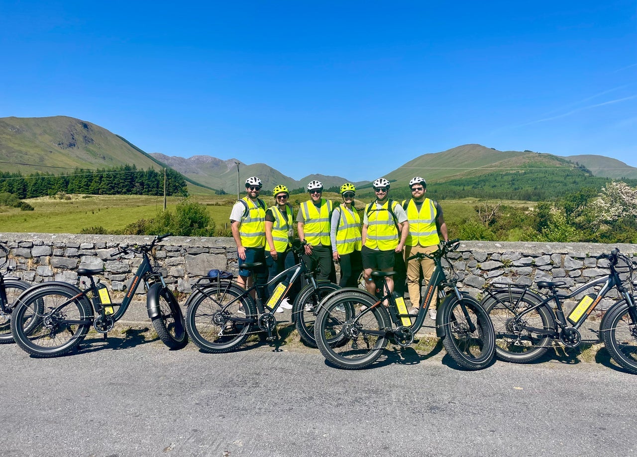 Cyclists with fat bikes under a blue sky