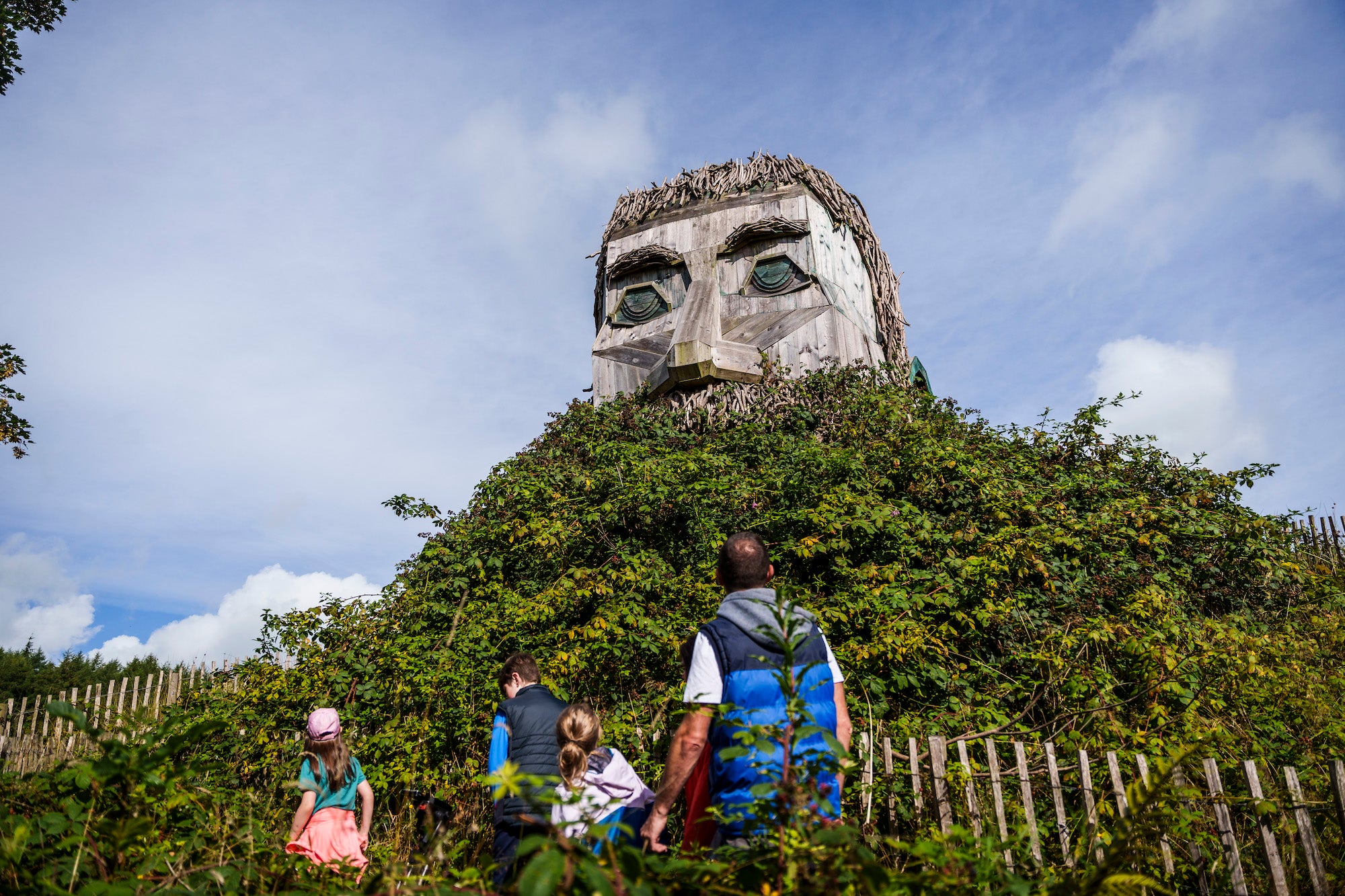 People walking past a sculpture in Rossmore Forest Park, Monaghan