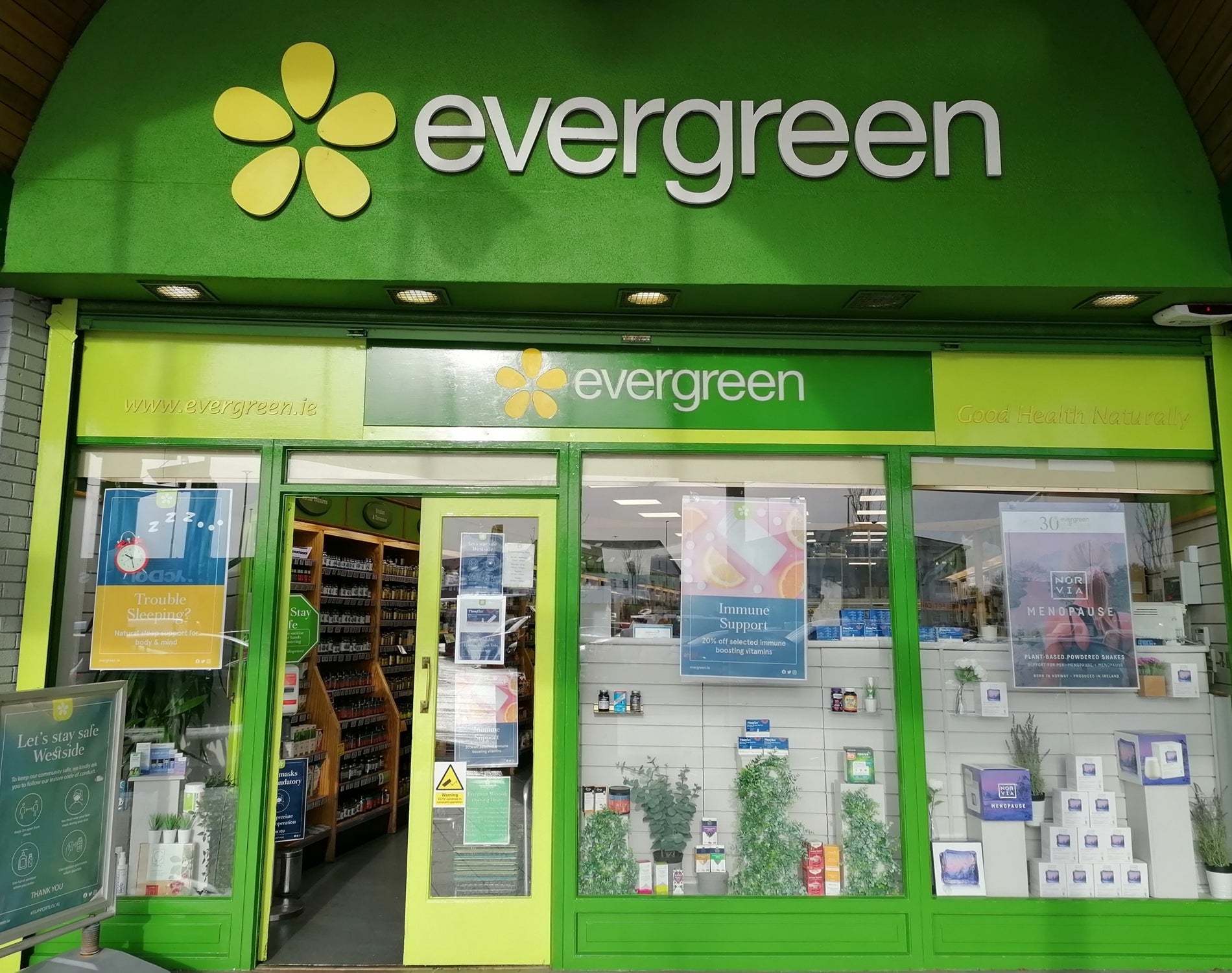 A shop exterior with different shades of green
