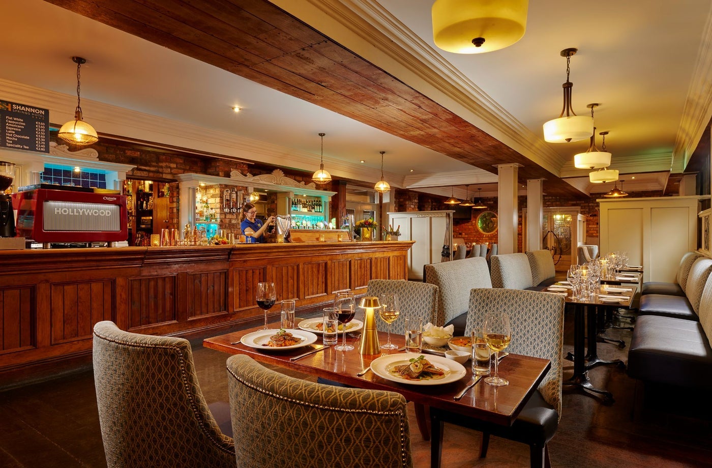 A dining area in a bar with prepared tables ready for diners