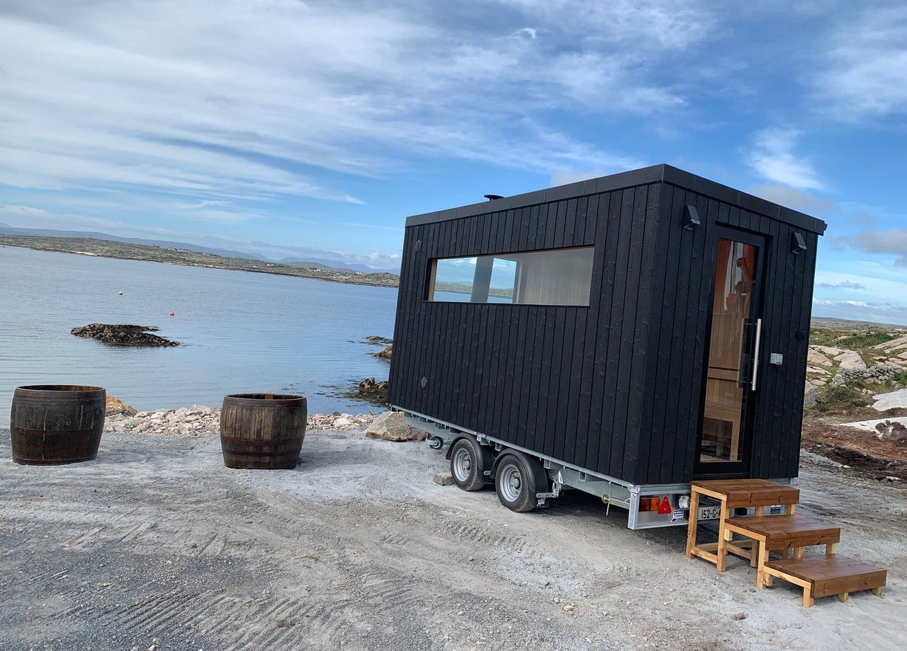 A small sauna and two half barrel seaweed baths beside a sea view