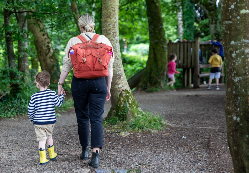 National Museum of Ireland, Turlough Park - rear view of adult and child walking in a wooded area