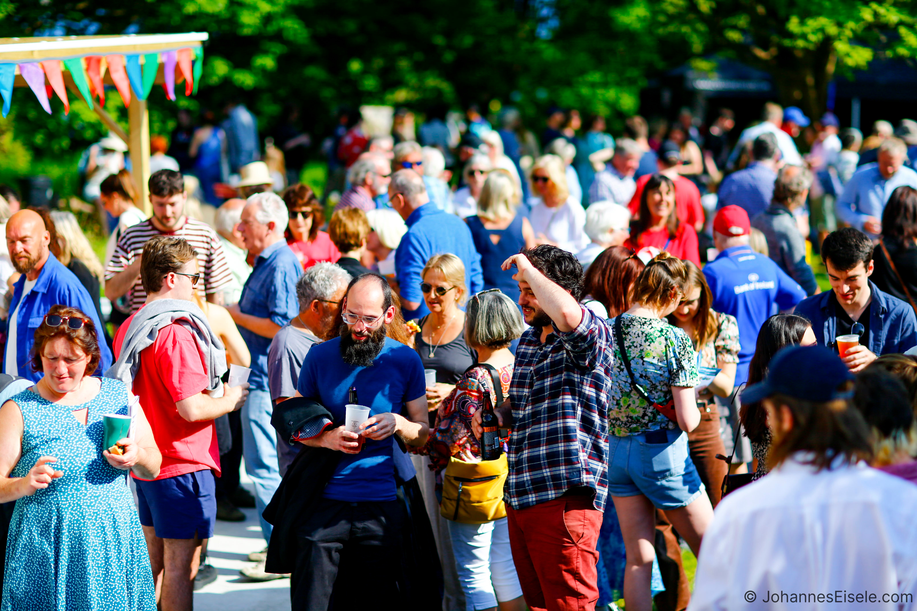 Visitors to Fastnet Film Festival 2024, enjoying the sunshine at the opening party in Schull.