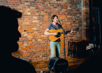 A singer with his guitar performing in a pub