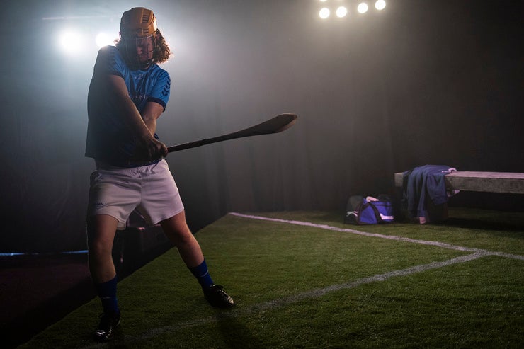 Dimly lit view of hurler on a pitch