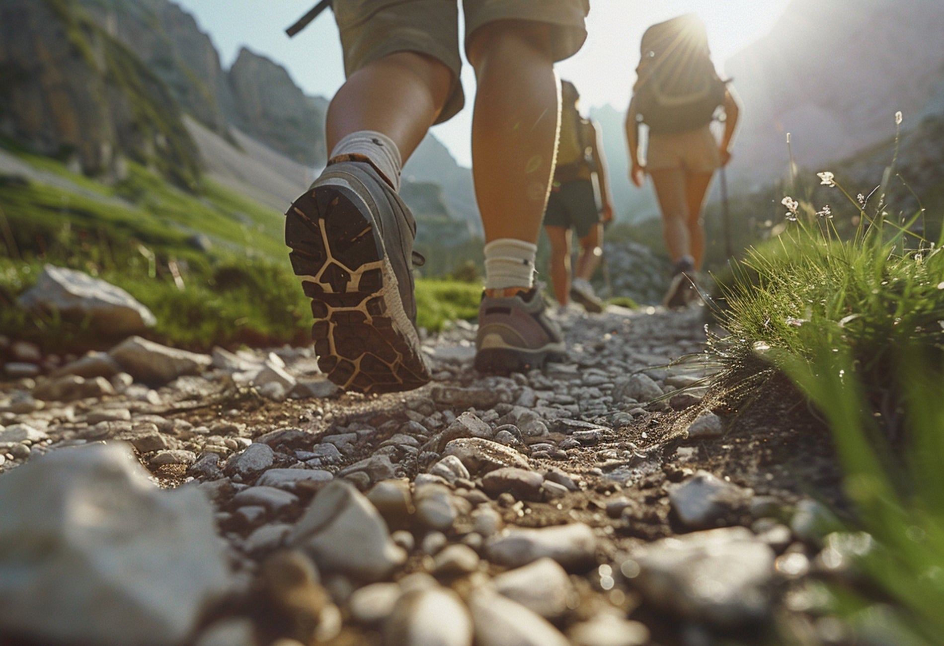 View from gravel path of three people hiking