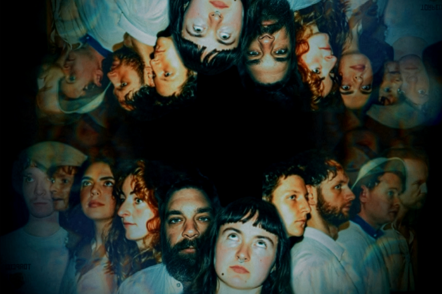 A line of headshots of people reflected above them upside down.