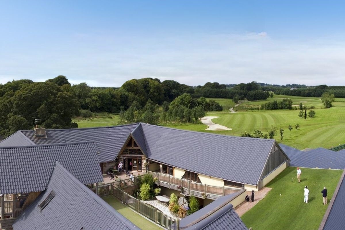 An aerial view of a golf club house and the course