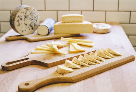 Selection of cheeses on serving board
