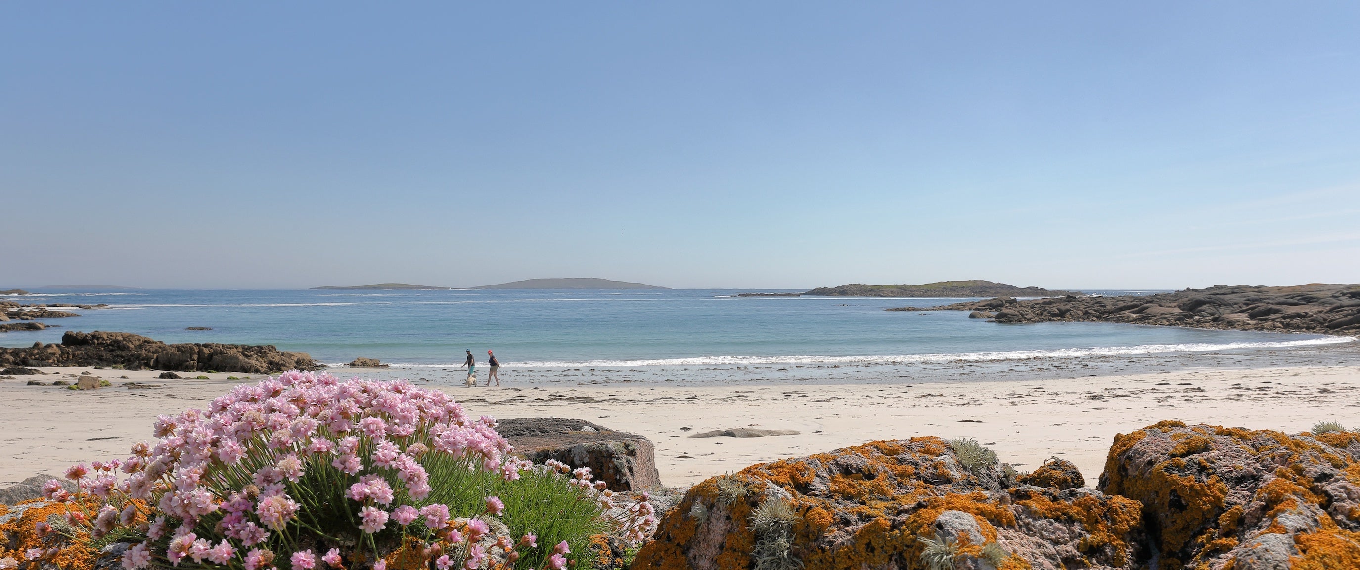 People walking on Renvyle Beach in Connemara, Co Galway