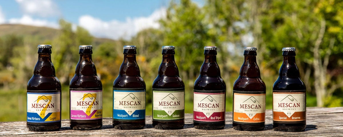 Selection of different types of Mescan bottled beer displyed on a table
