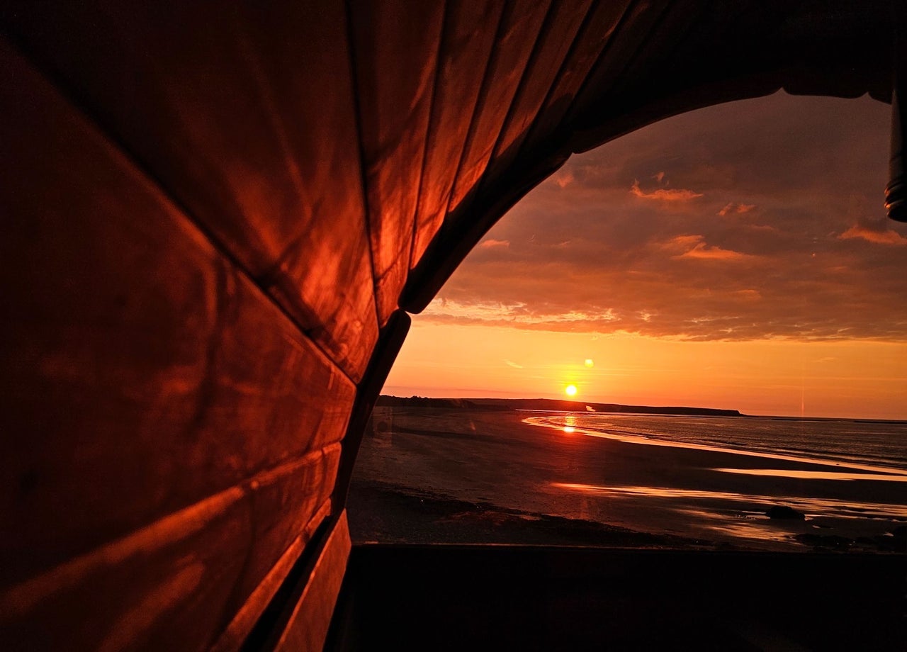 View of the beach from a sauna at sunset