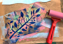 Monoprinting with Susan Leen - Looking down at a printed, layered image of a branch with different colours and a small roller.