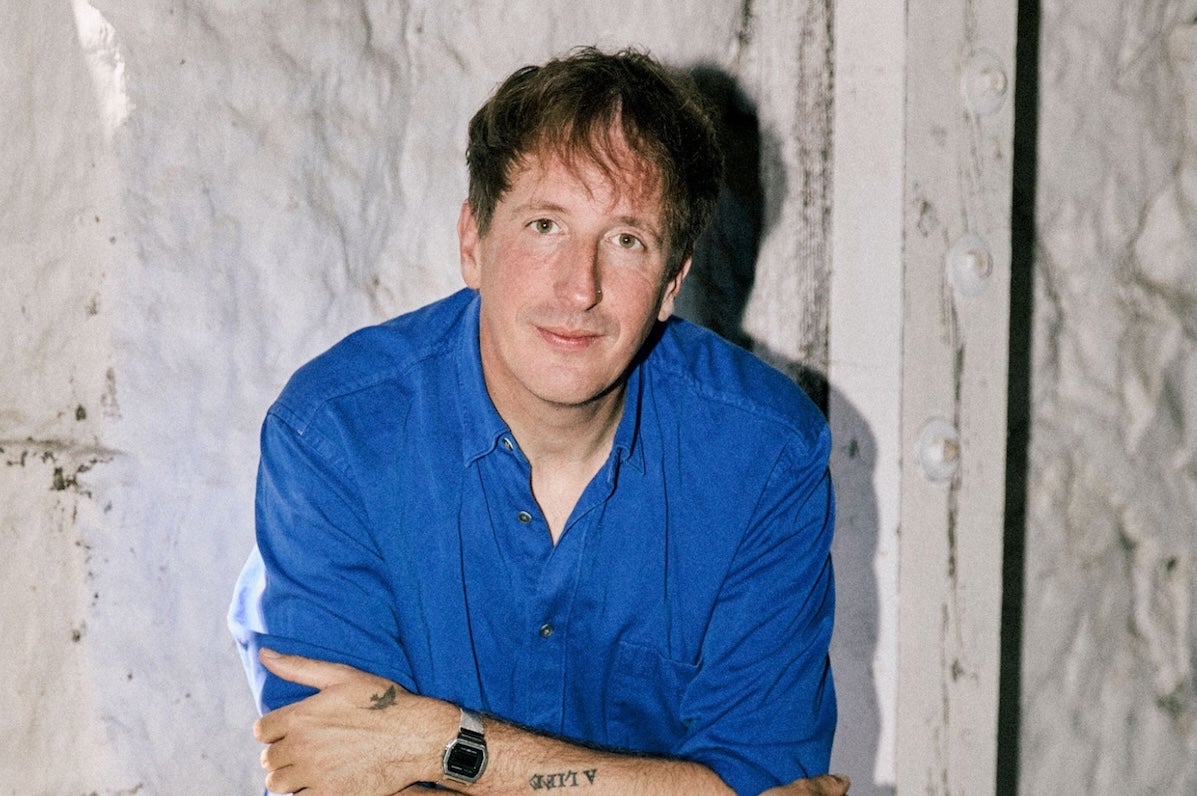 German producer and artist, Christian Löffler, man in dark blue shirt with arms crossed.
