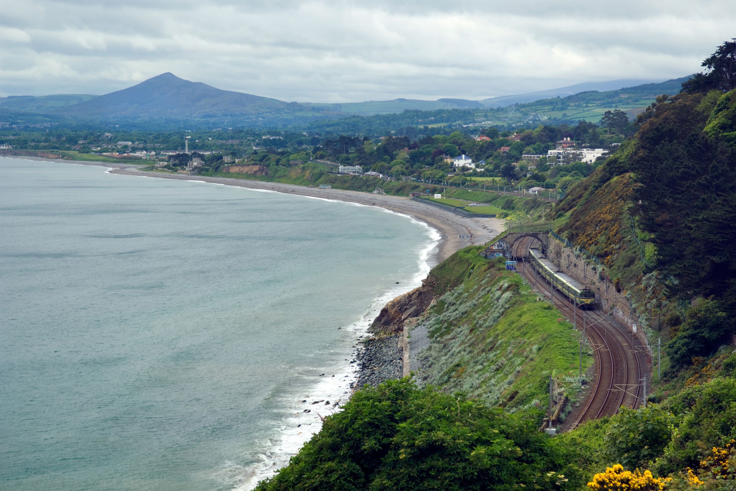 The DART line running past mountains by the coast at Vico, Dalkey, Dublin
