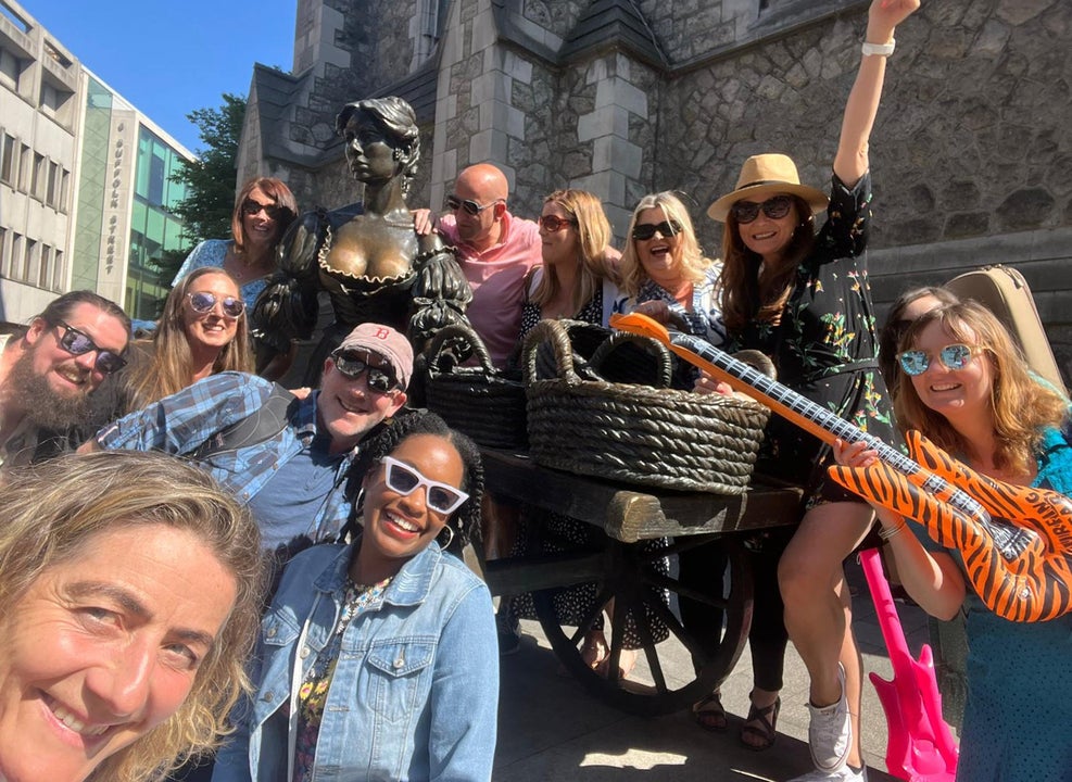 A group of people at the Molly Malone statute in Dublin on a Songwriters Tour