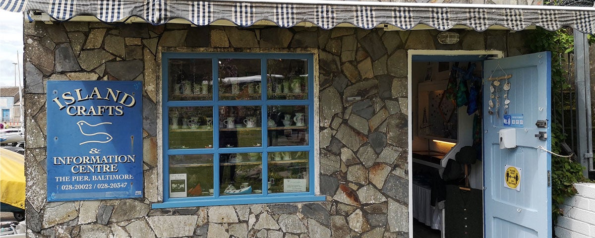 Traditional stone exterior wall and open door of Island Crafts