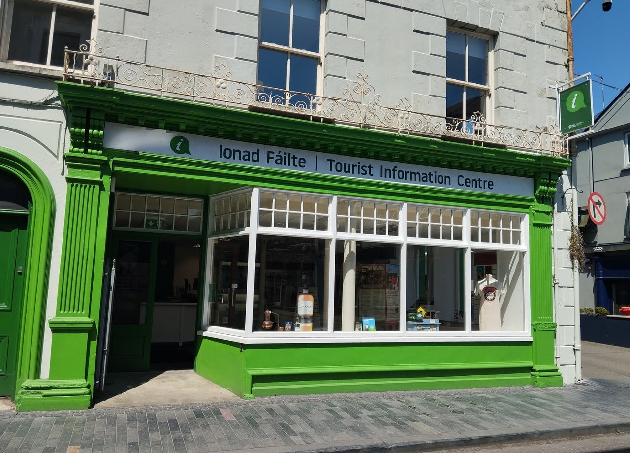 Exterior of a tourist office with the name in Irish and English above the windows