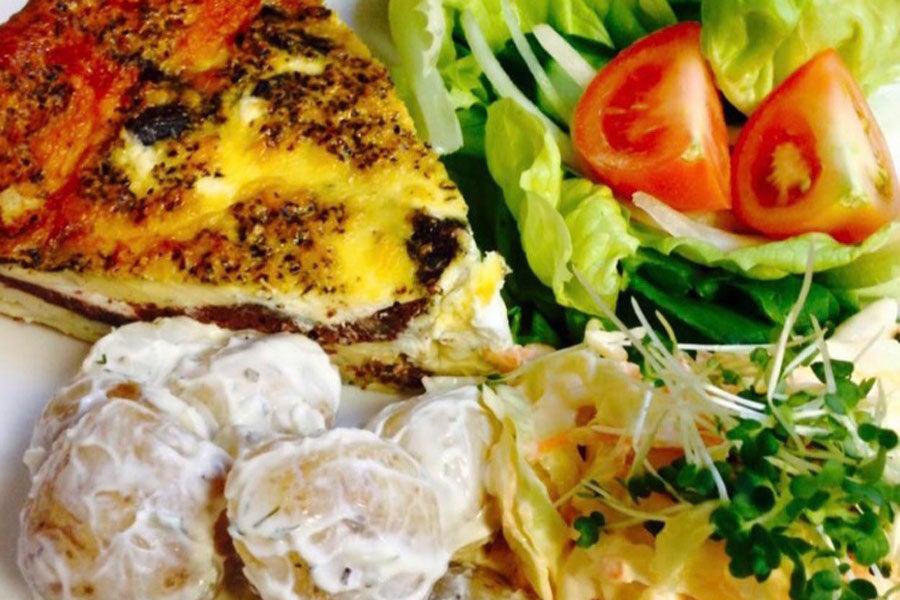 A quiche with salad on a plate