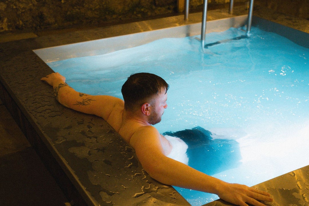 A person relaxing in a heated plunge pool at Helios Sauna Dundrum