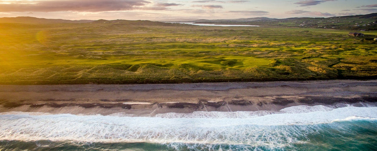A panoramic view of Ballyliffin Golf Club with the sea in the foreground