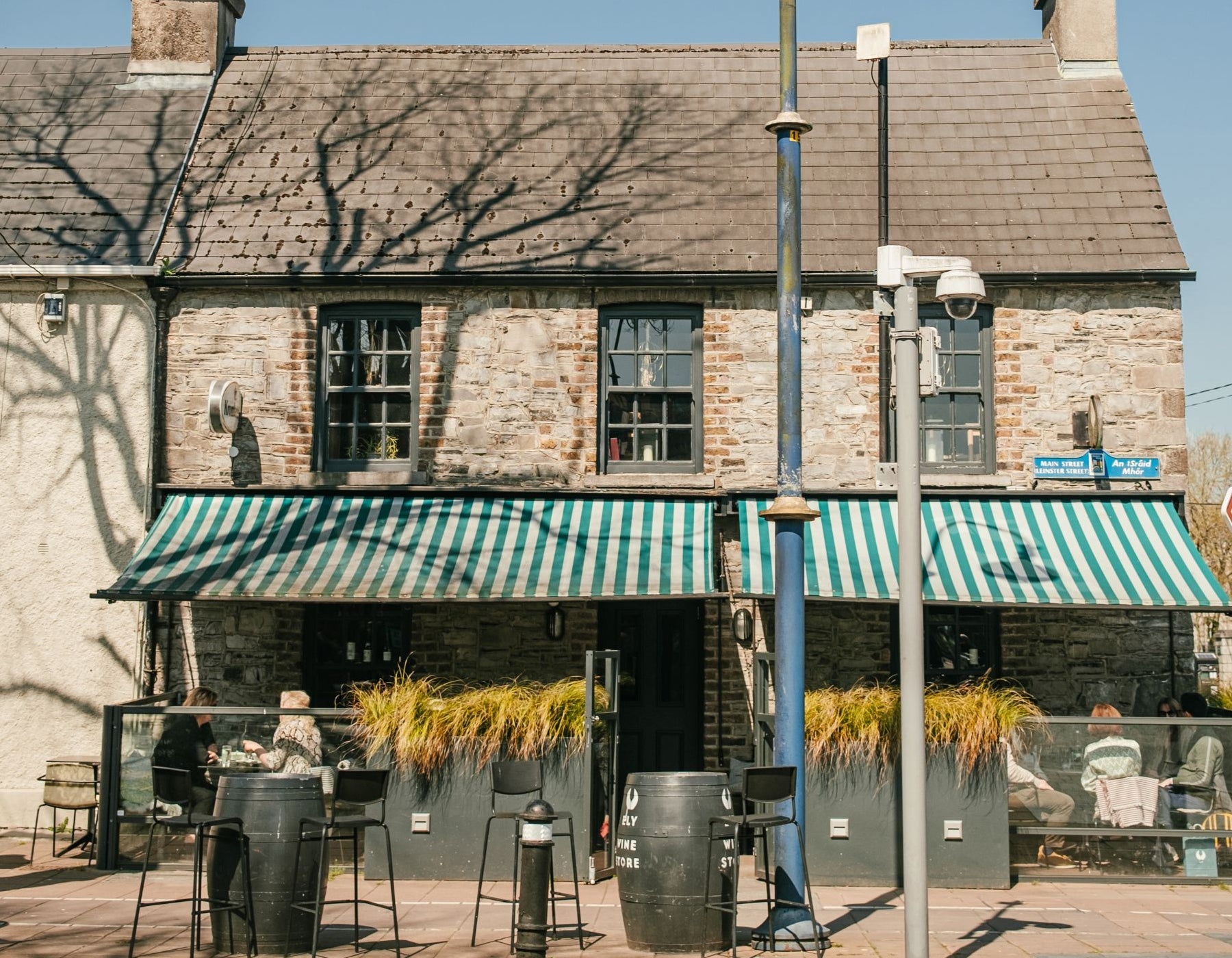 View of the ELY Wine Store and outside seating area from the street