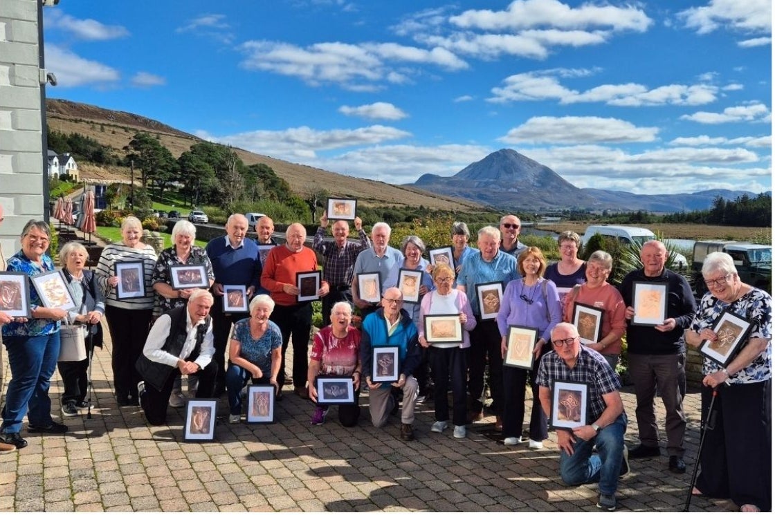 Large group of people on a sunny day holding their craft works