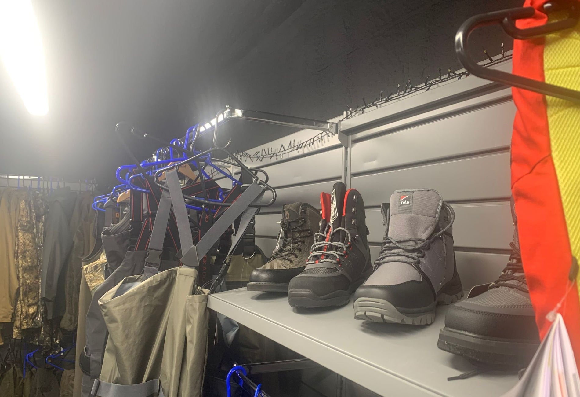 A selection of hiking boots and outdoor clothing for sale