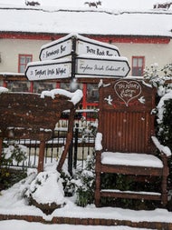 A view of Taylors Three Rock love chair and traditional sign posts