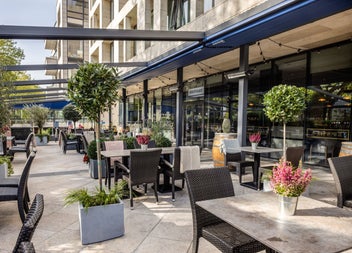 An outdoor terrace with comfortable seating and landscaped surroundings