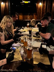 A table full of guests bent over their practice skins, tattoo machines buzzing as they concentrate on their designs. Drinks pushed aside, all focus on the art at Dublin’s most creative night out.