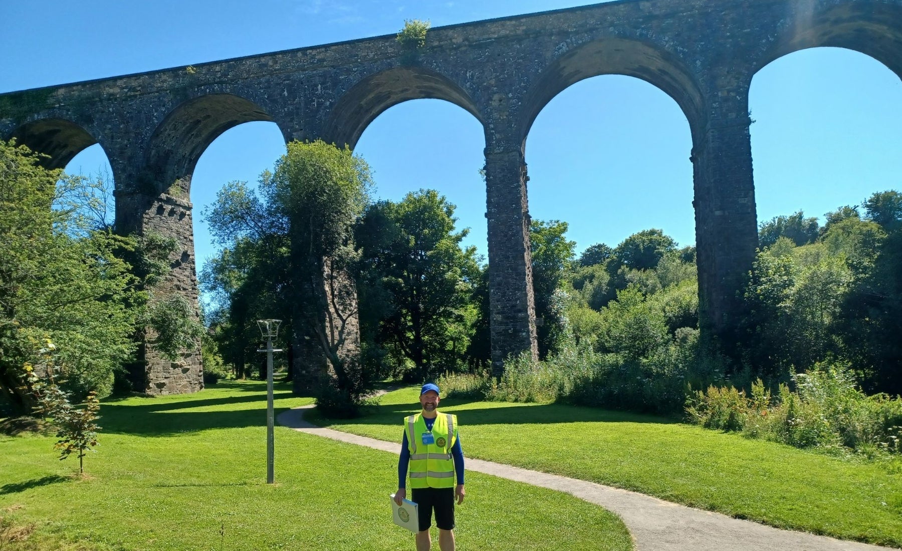 A view of a walking guide standing beside the Kilmacthomas Viaduct