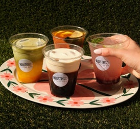 Selection of four iced coffees and refreshing drinks on a flower patterned plate