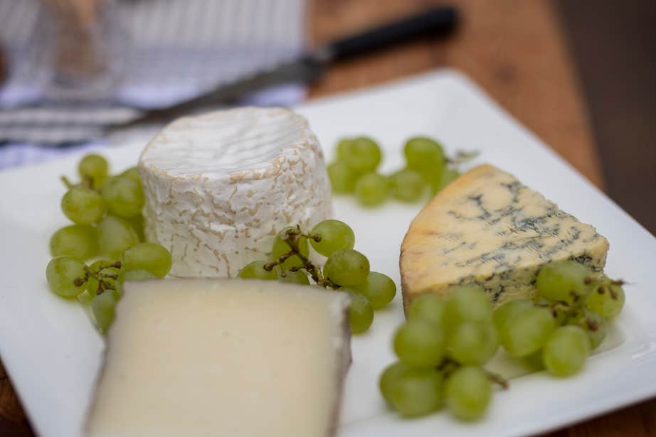 Cheese and grapes on a plate.