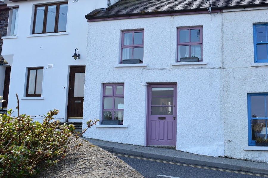 Front view of property with purple door